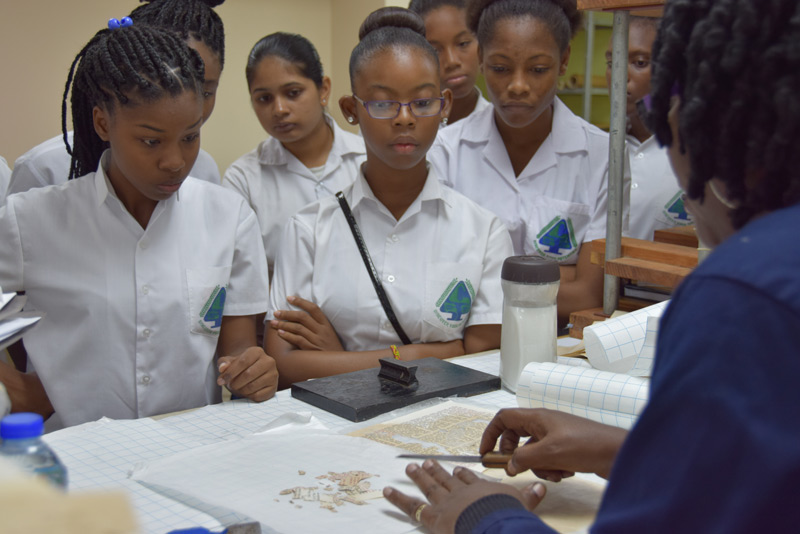 Intensely observing how damaged documents are restored in the Conservation Lab